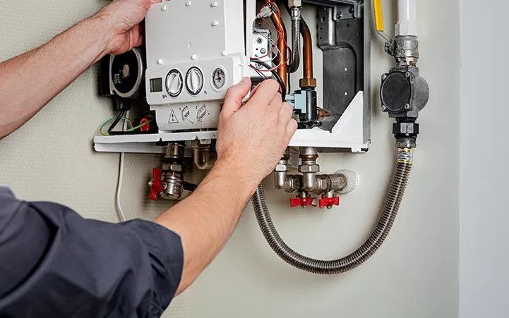 A man skillfully repairing a gas boiler with focused concentration